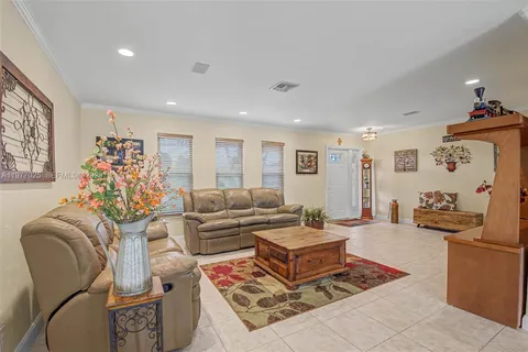a living room with furniture rug and lamp