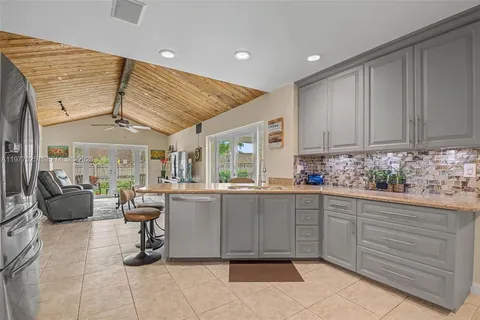 a kitchen with sink cabinets and window