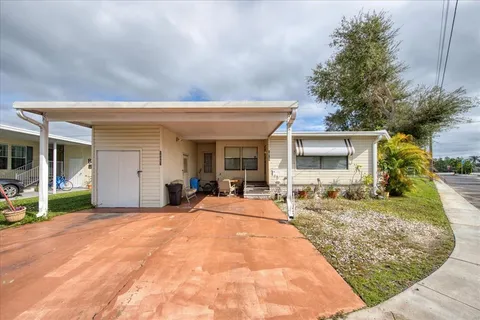 a view of a house with backyard porch and sitting area
