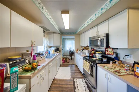 a kitchen with lots of counter top space a sink a stove and a window