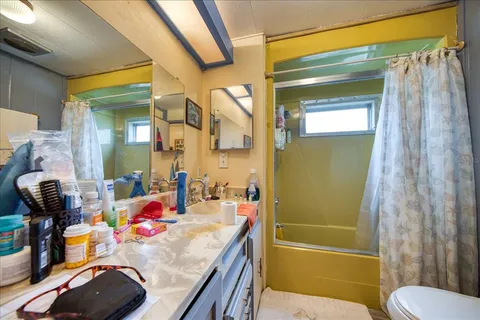 a bathroom with a sink toilet and shower