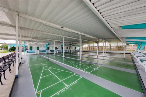 a view of a swimming pool with a patio and a backyard
