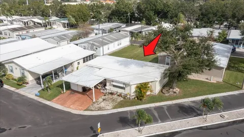 an aerial view of a house with swimming pool and outdoor seating