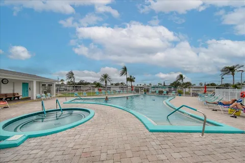 an outdoor space with swimming pool and seating