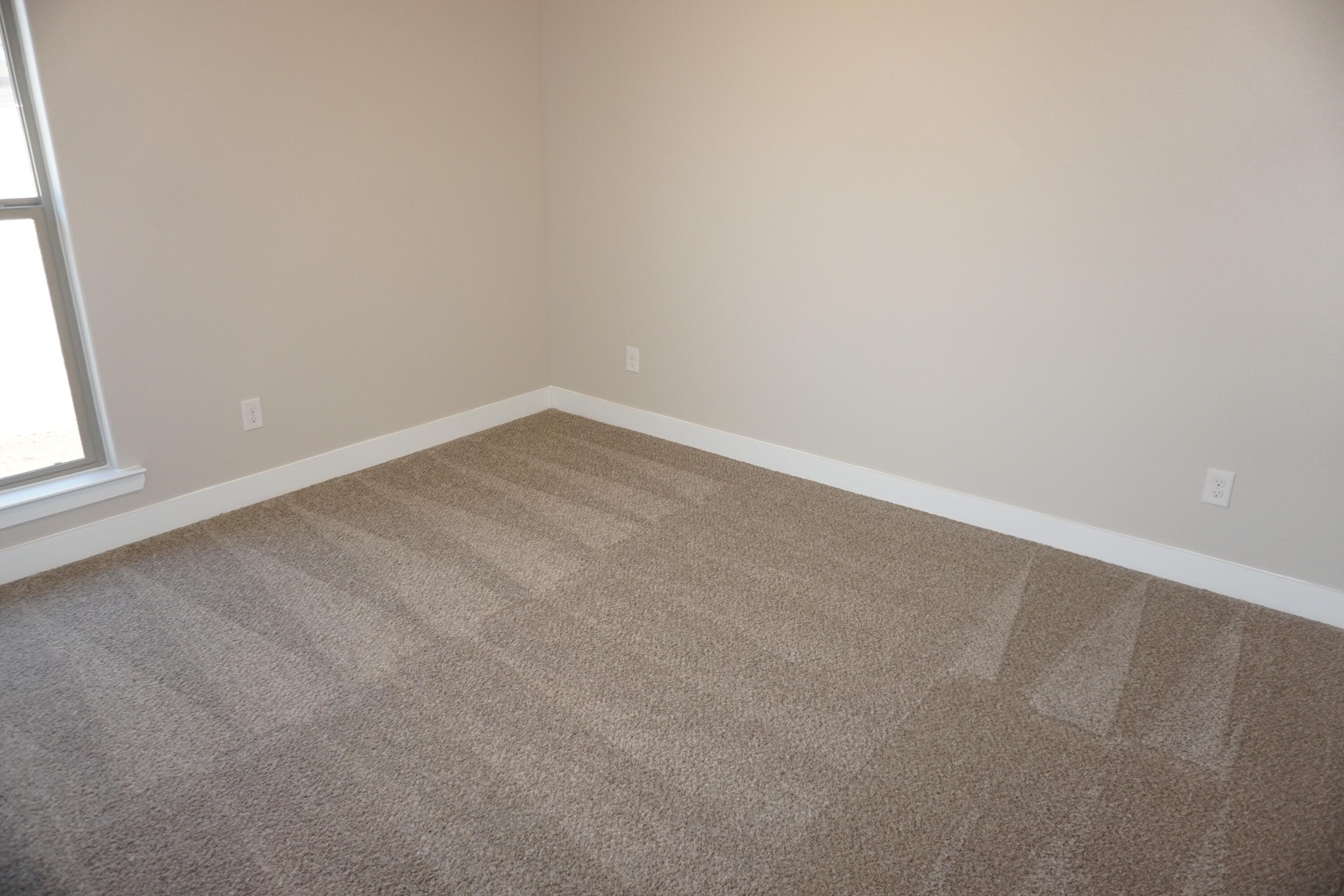 7517 31st Street Lubbock, TX 79407 - Photo 8 of 14 an empty room with a window