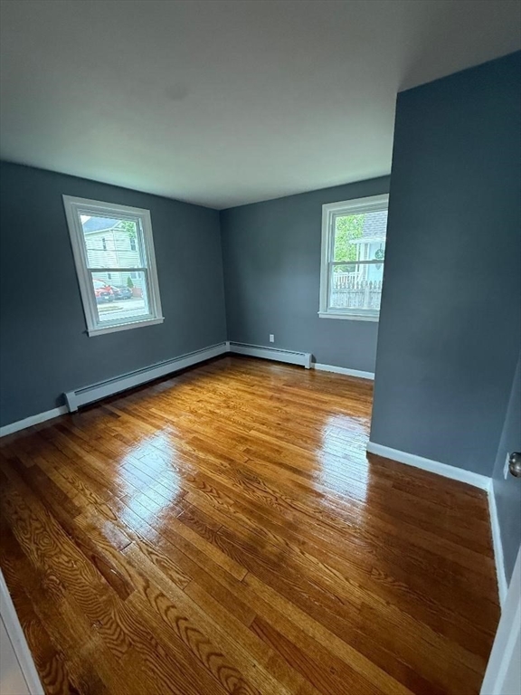 45 Penacook Street Springfield, MA 01104 - Photo 14 of 27 an empty room with wooden floor and windows
