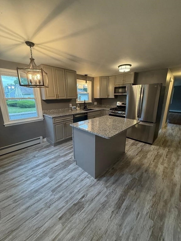45 Penacook Street Springfield, MA 01104 - Photo 8 of 27 a large kitchen with stainless steel appliances granite countertop a large counter top and wooden floors