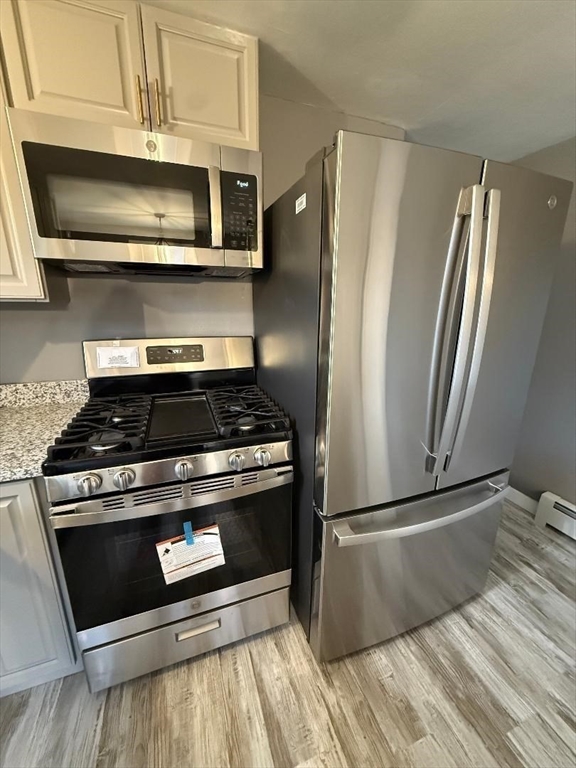 45 Penacook Street Springfield, MA 01104 - Photo 10 of 27 a stove top oven sitting inside of a kitchen