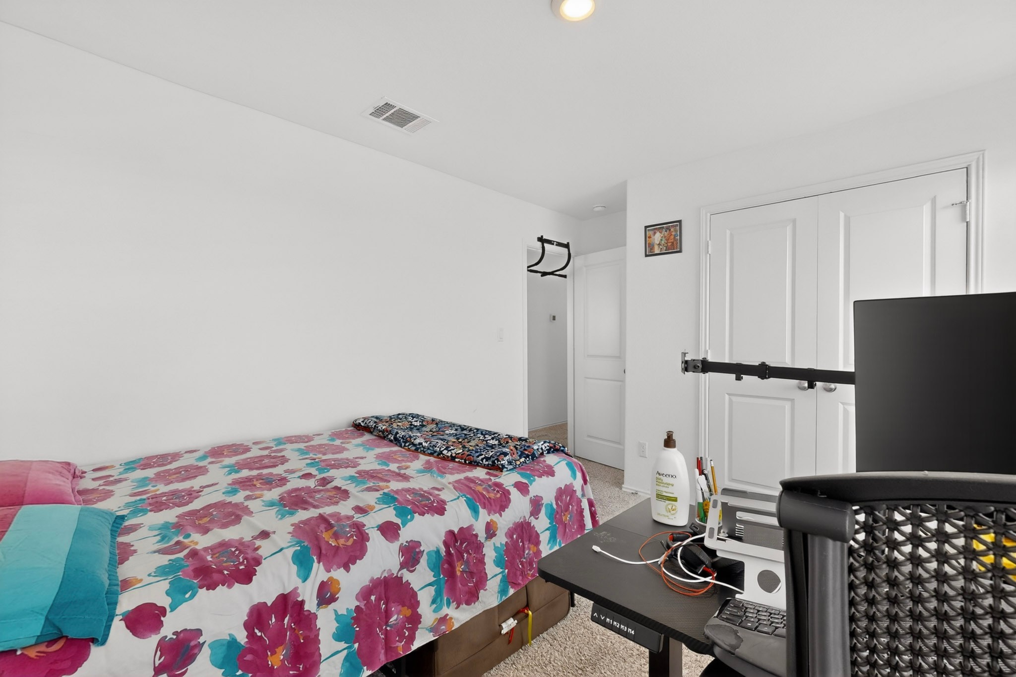 936 Mallow Road Leander, TX 78641 - Photo 12 of 16 Carpeted room with white walls, a recessed light, and a built-in closet with bifold doors