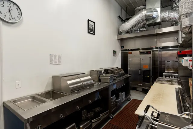 a room with lots of tables a chandelier and a dining table