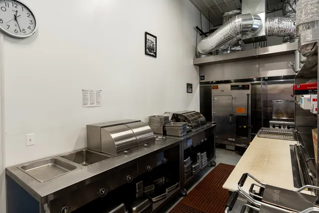 a room with stainless steel appliances granite countertop lots of counter top space