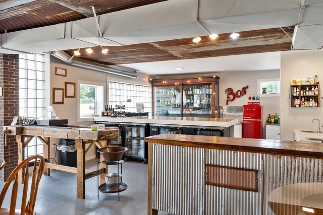 a backyard of a house with a table and chairs