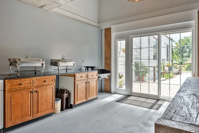 a kitchen with cabinets and a clock on the wall