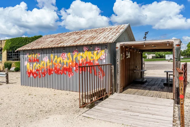a view of a water fountain with potted plants
