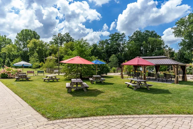 a view of a patio with a table and chairs under an umbrella
