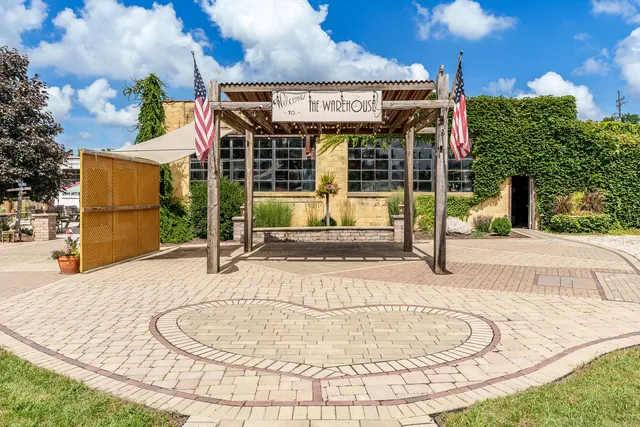 a kitchen with stainless steel appliances granite countertop a refrigerator sink and white cabinets