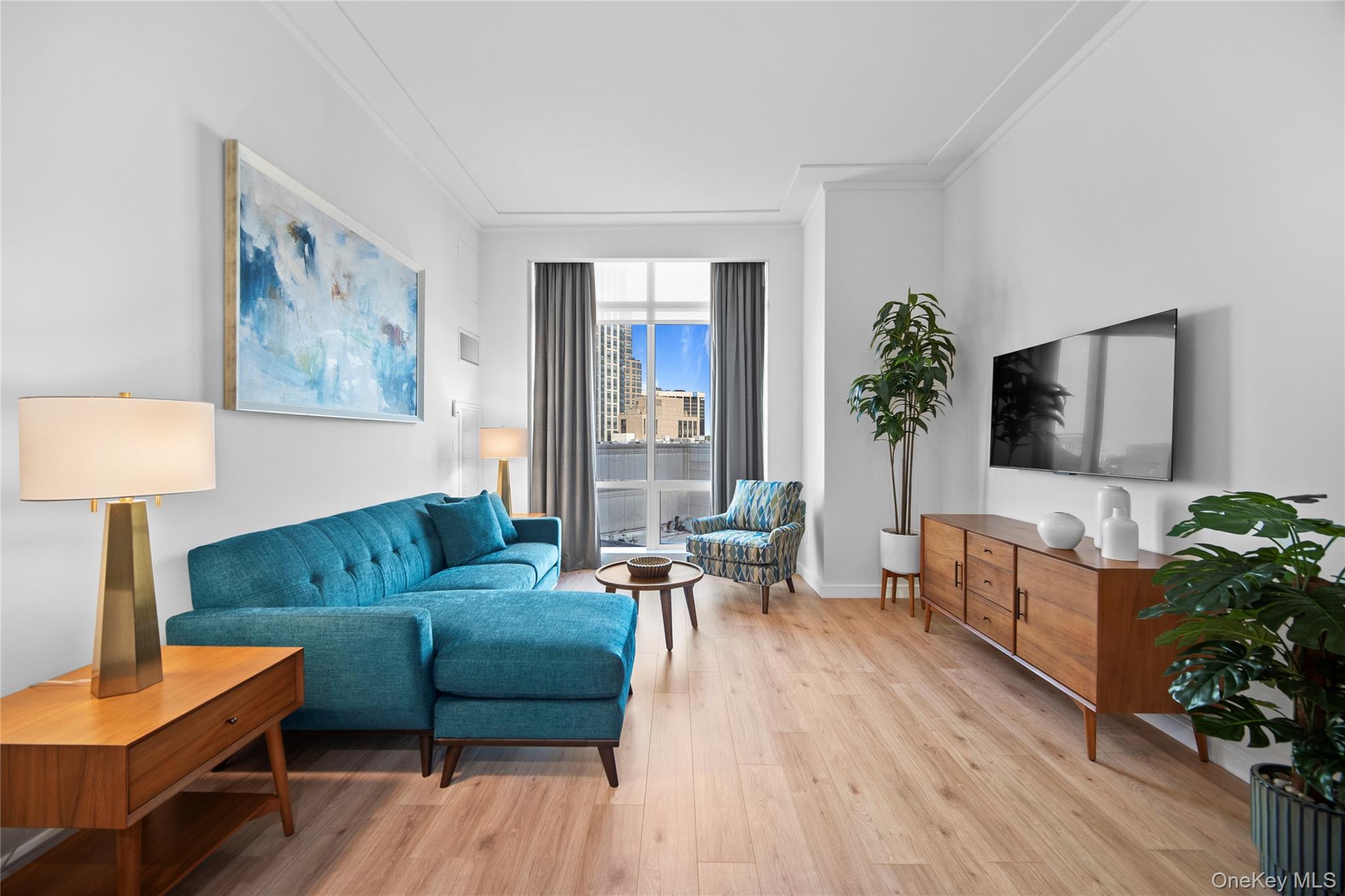 1 Renaissance Square, Unit 10C White Plains, NY 10601 - Photo 1 of 28 a living room with furniture and a flat screen tv