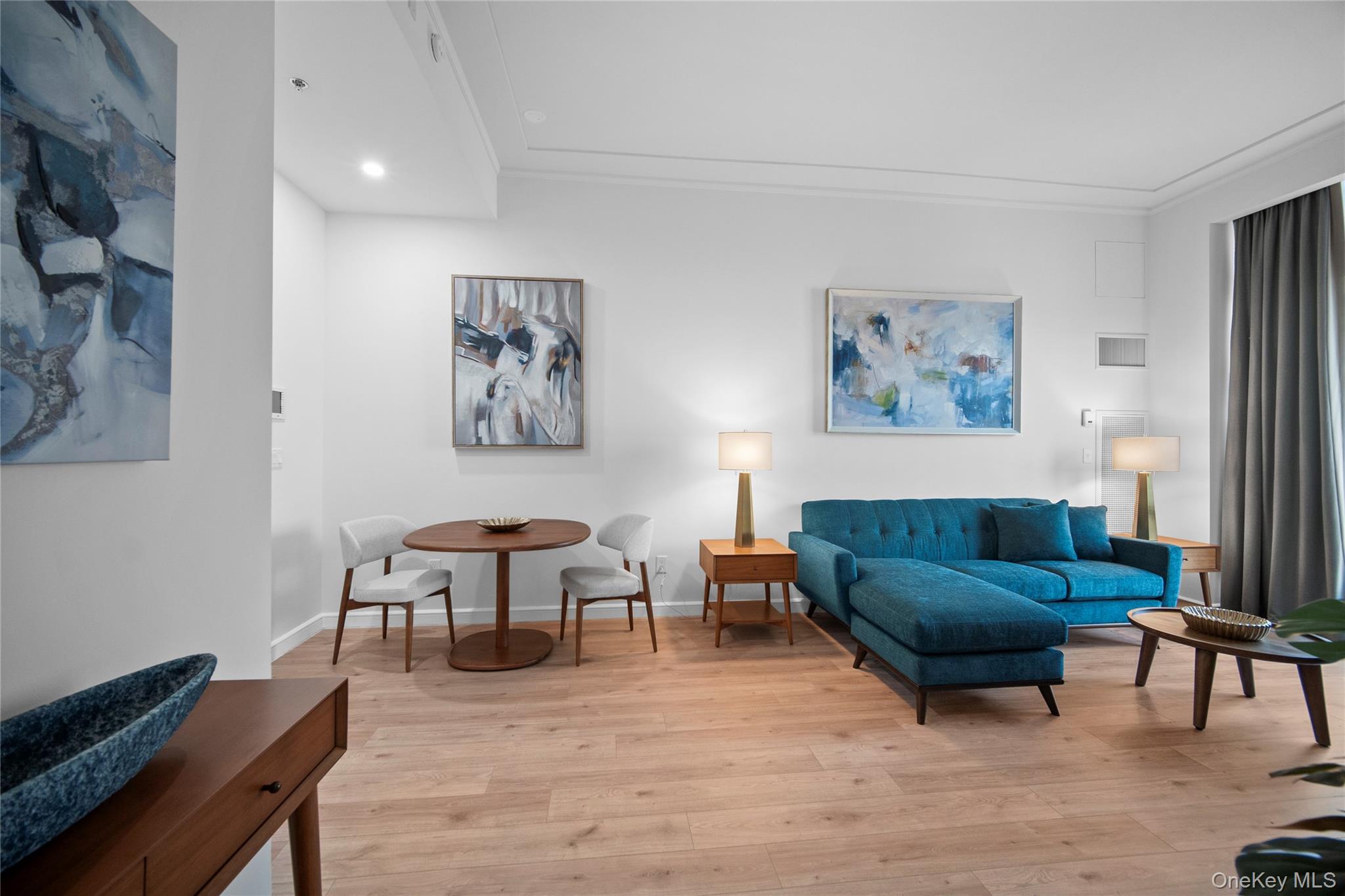 1 Renaissance Square, Unit 10C White Plains, NY 10601 - Photo 2 of 28 a living room with furniture and a wooden floor