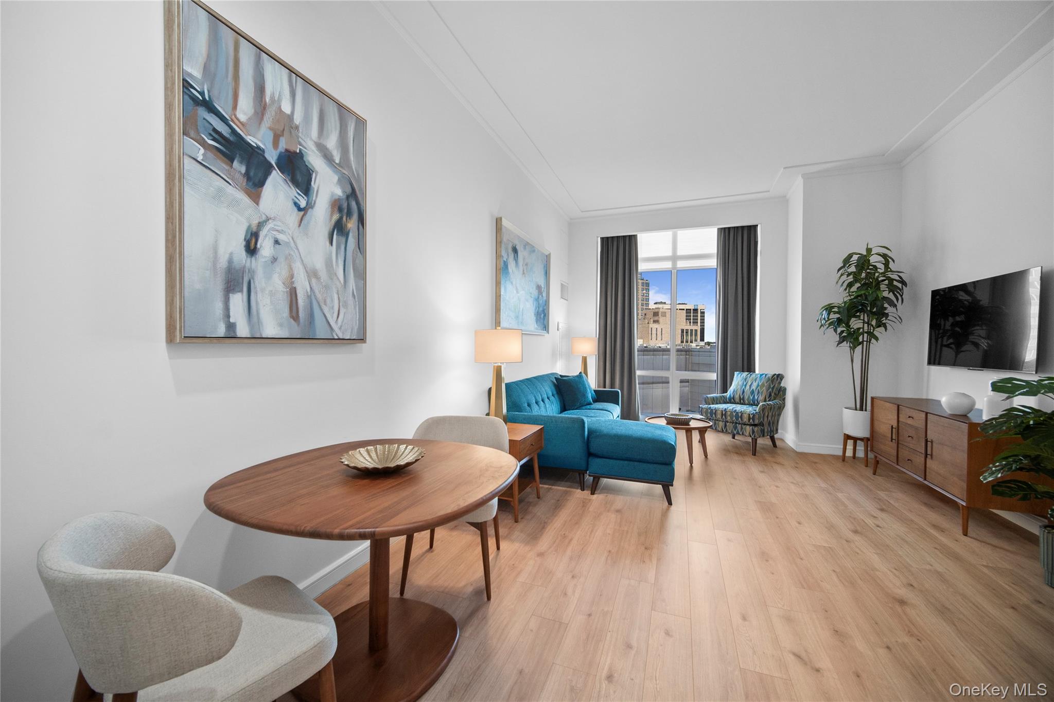 1 Renaissance Square, Unit 10C White Plains, NY 10601 - Photo 5 of 28 a living room with furniture and a flat screen tv