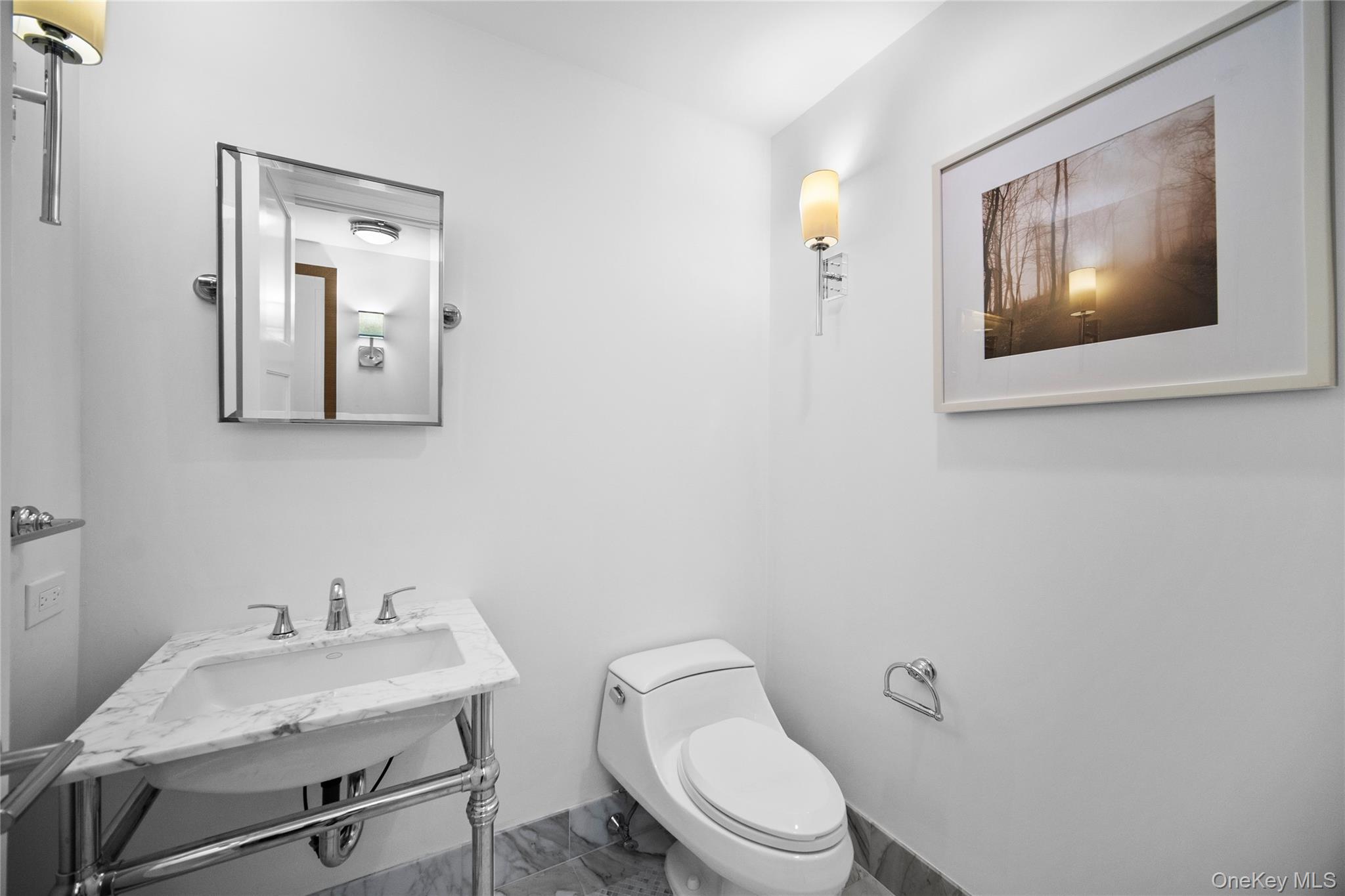 1 Renaissance Square, Unit 10C White Plains, NY 10601 - Photo 9 of 28 a bathroom with a toilet sink and mirror
