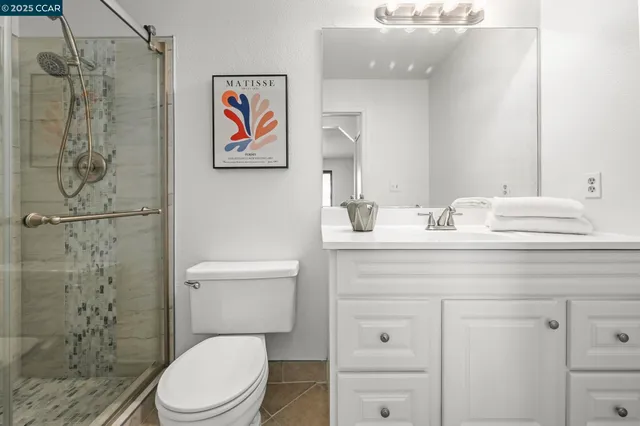 a white toilet sitting next to a bathroom sink