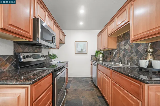 a stove top oven sitting inside of a kitchen