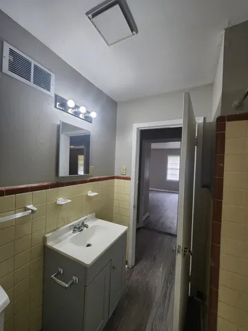 a bathroom with a sink a toilet and mirror