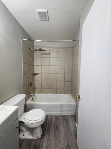 a bathroom with a toilet a sink and bathtub