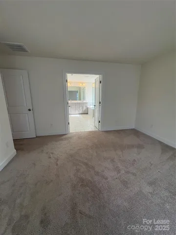 a view of an empty room and a window