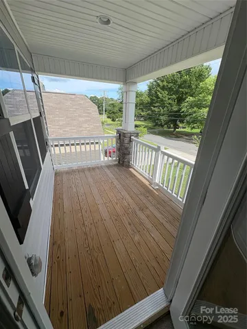 a view of balcony with wooden floor