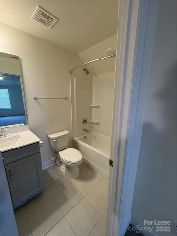 a white toilet sitting next to a bathroom sink