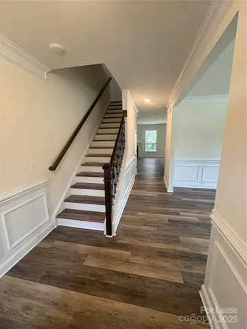 a view of entryway and hall with wooden floor