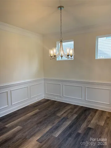 a view of a room with cabinet and chandelier