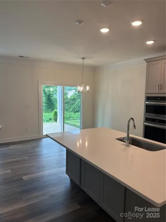 a kitchen with kitchen island a sink stainless steel appliances and cabinets