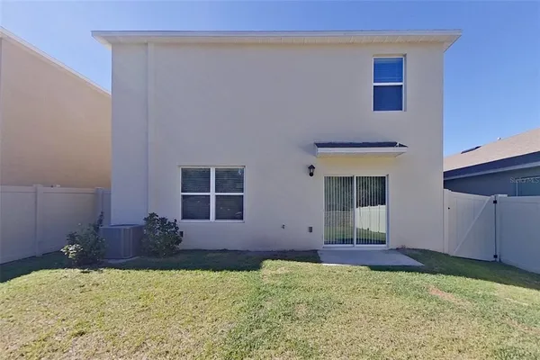 a view of front door and small yard