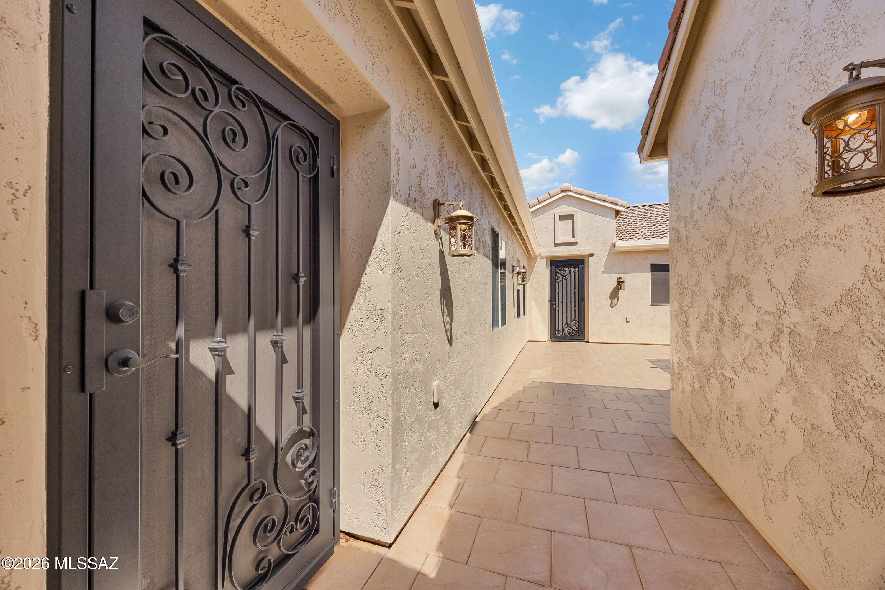63200 East Flower Ridge Drive Tucson, AZ 85739 - Photo 7 of 50 Tiled walkway to enclosed Courtyard