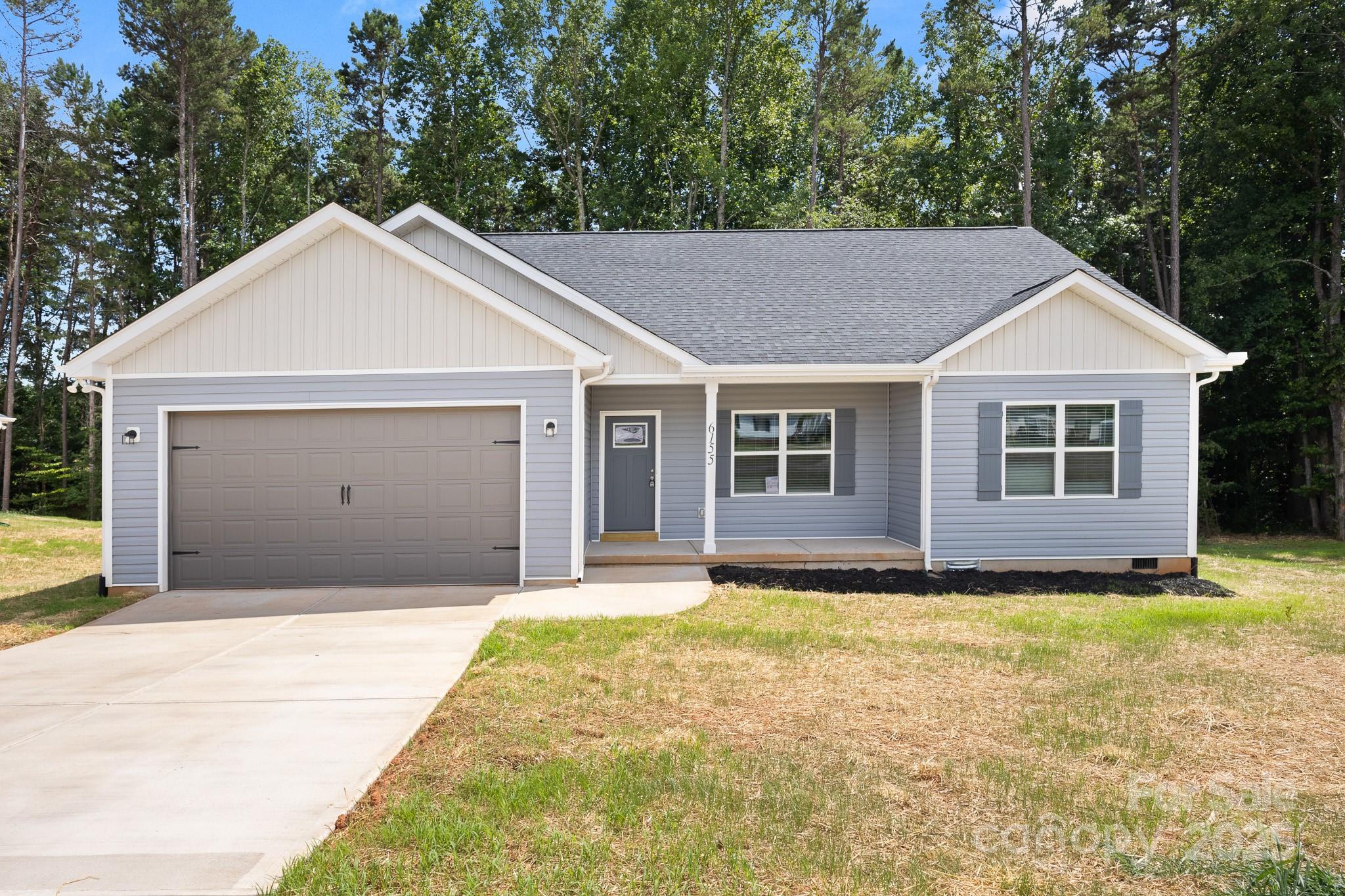 a front view of a house with yard and garage