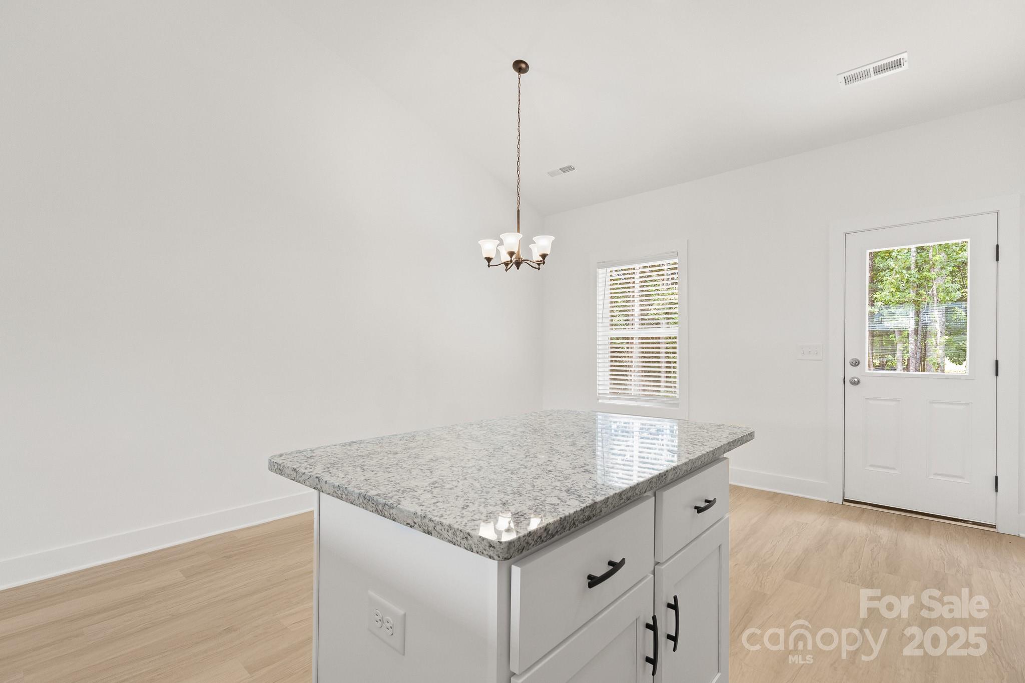 6155 Long Branch Road Salisbury, NC 28147 - Photo 13 of 35 a kitchen with granite countertop cabinets and wooden floor