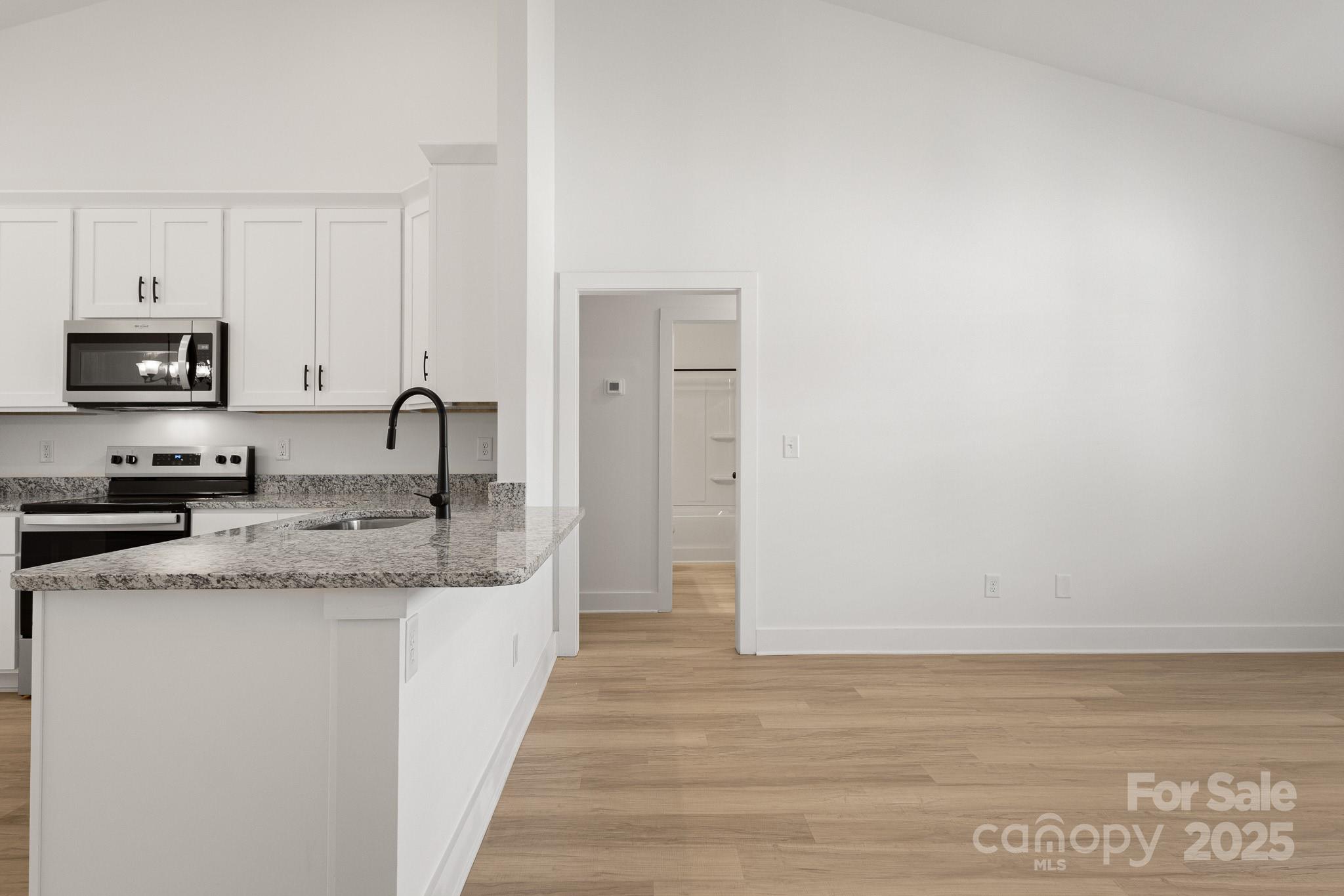 6155 Long Branch Road Salisbury, NC 28147 - Photo 26 of 35 a kitchen with granite countertop a sink and a stove top oven