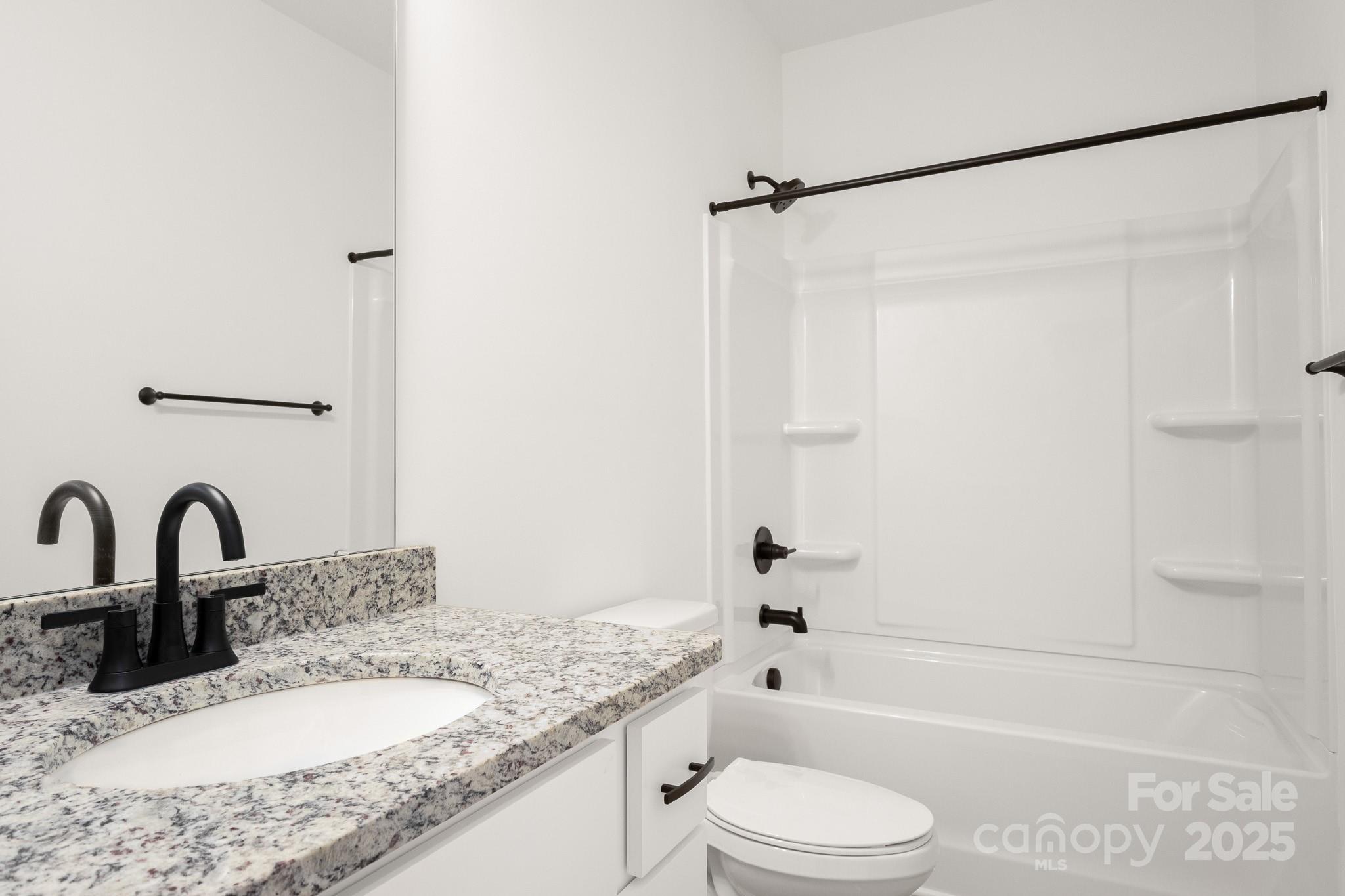 6155 Long Branch Road Salisbury, NC 28147 - Photo 27 of 35 a bathroom with a granite countertop sink toilet and shower