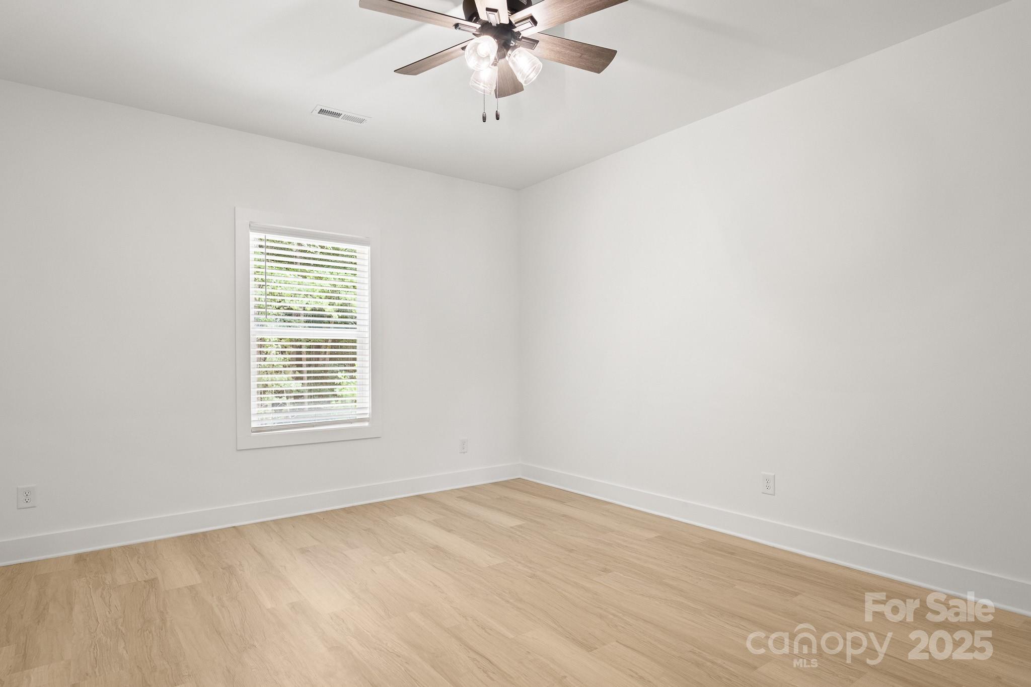 6155 Long Branch Road Salisbury, NC 28147 - Photo 29 of 35 an empty room with a window and a ceiling fan