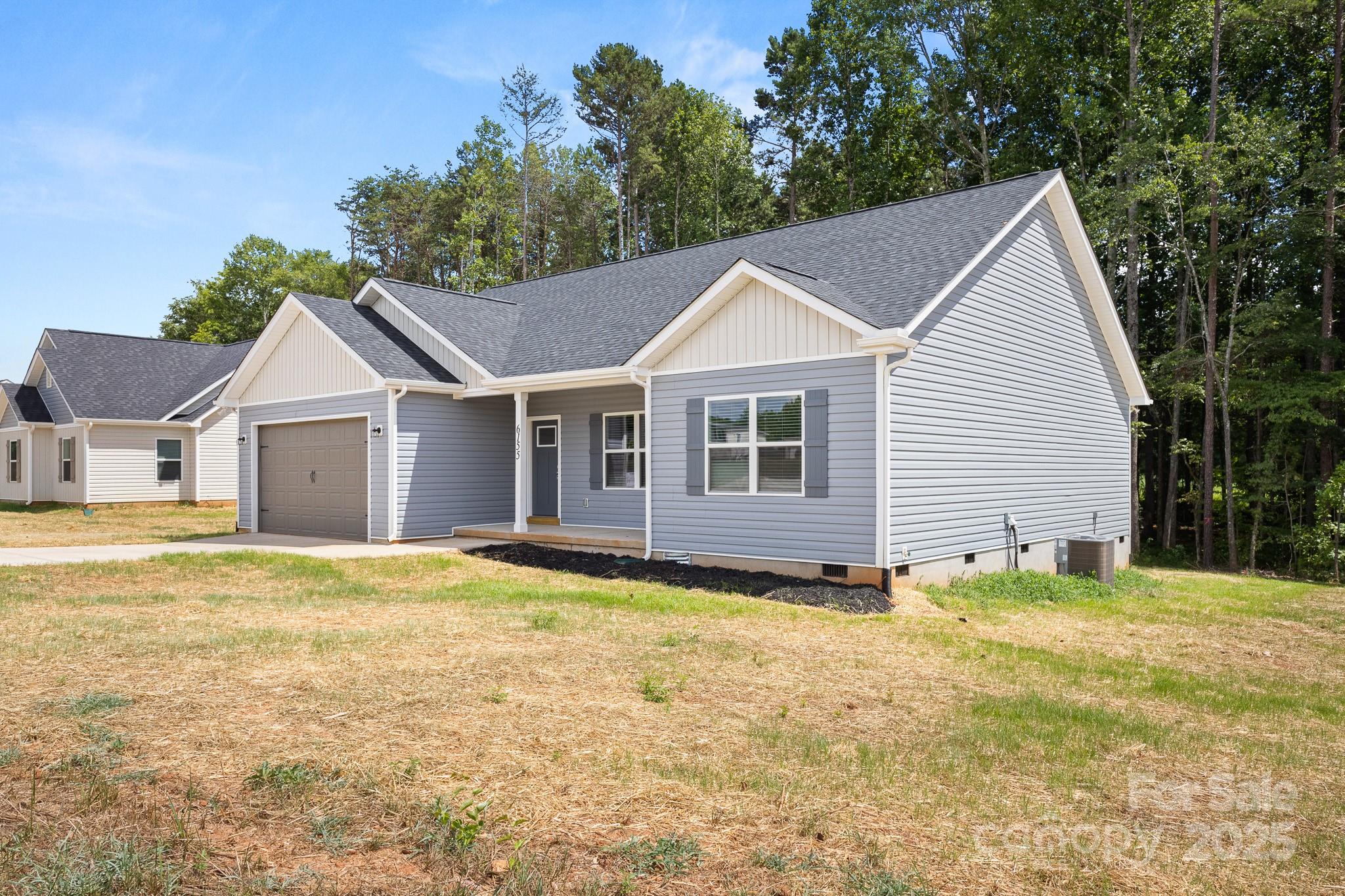 6155 Long Branch Road Salisbury, NC 28147 - Photo 3 of 35 a view of a house with yard and trees in the background