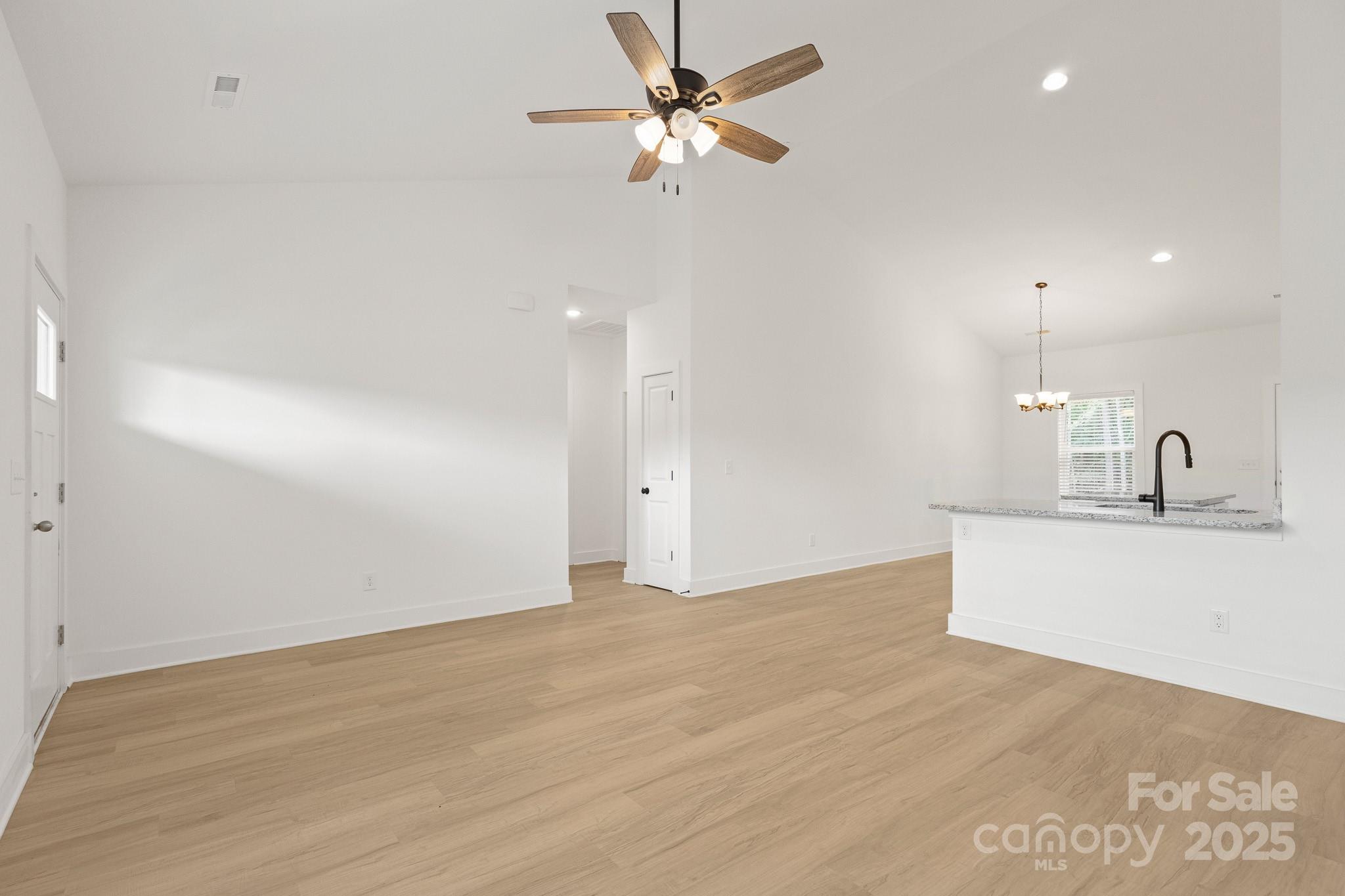 6155 Long Branch Road Salisbury, NC 28147 - Photo 5 of 35 a view of a kitchen with a sink and a chandelier fan