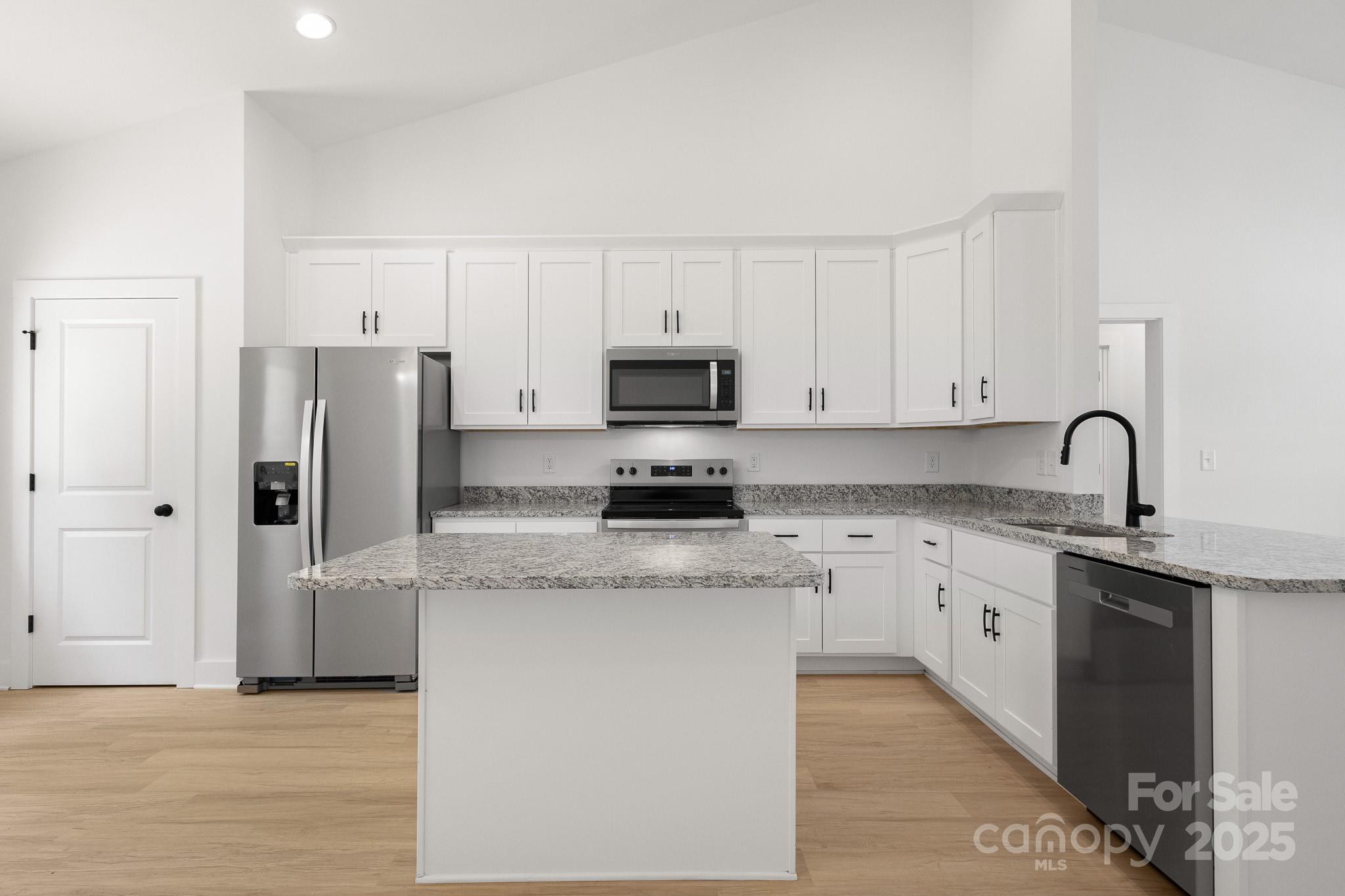 6155 Long Branch Road Salisbury, NC 28147 - Photo 10 of 35 a kitchen with stainless steel appliances granite countertop a stove a sink and a refrigerator