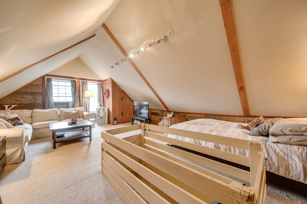 6 Oak Street Grafton, MA 01519 - Photo 19 of 27 a spacious bedroom with a bed couch and a window