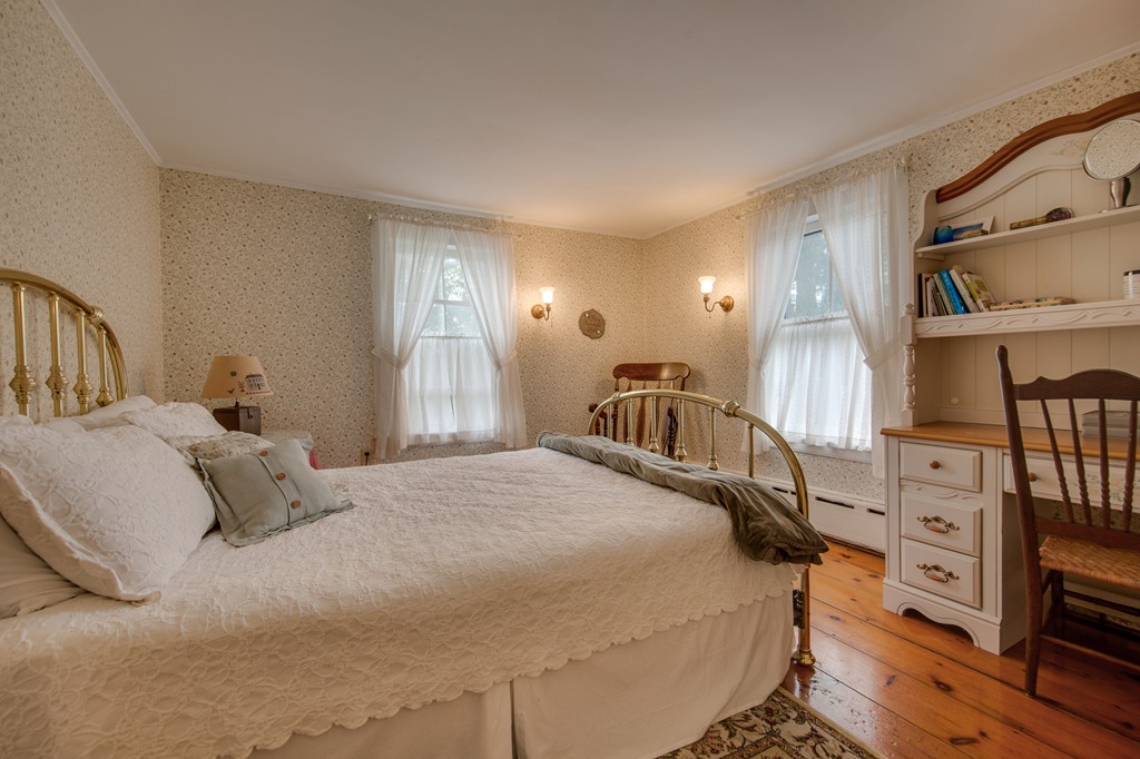 6 Oak Street Grafton, MA 01519 - Photo 21 of 27 a bedroom with a bed a dresser and book racks