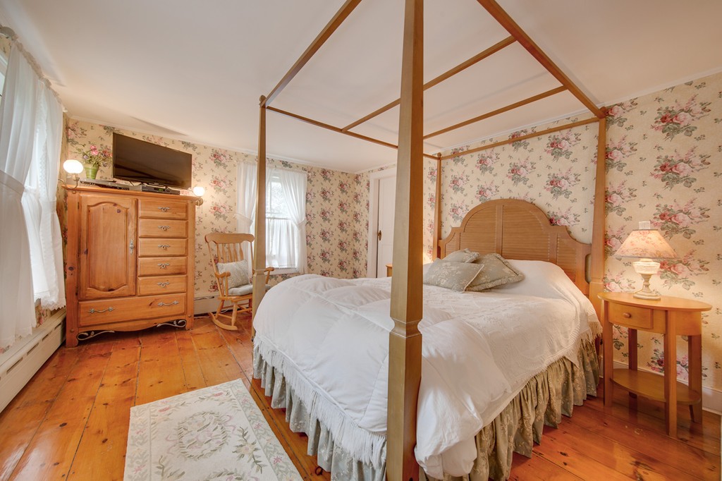 6 Oak Street Grafton, MA 01519 - Photo 22 of 27 a bedroom with a bed window and a flat tv screen on the table