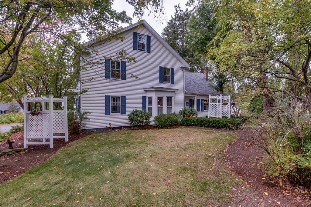 6 Oak Street Grafton, MA 01519 - Photo 3 of 27 a front view of a house with a garden and trees