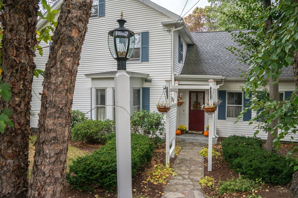 6 Oak Street Grafton, MA 01519 - Photo 4 of 27 front view of a house with potted plants