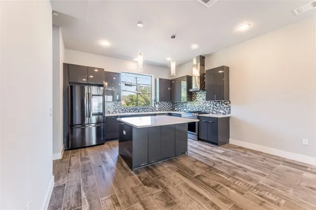 a kitchen with a stove and a refrigerator